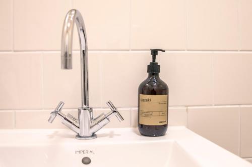 a bottle of wine sitting on top of a sink at Fuglsang Herregaard Hotel in Nykøbing Falster