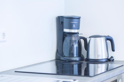 a coffee maker and a coffee pot on a counter at Il Mare appart hotel 1,2,4 in Luxembourg
