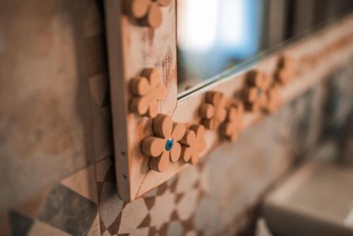 a bunch of wooden buttons on a wall at B&B LELLA in Piove di Sacco