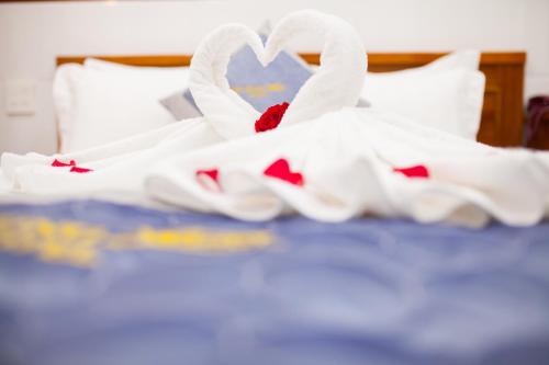 a bed with white towels and a heart on it at Thy Hung legacy hotel in Tuy Hoa