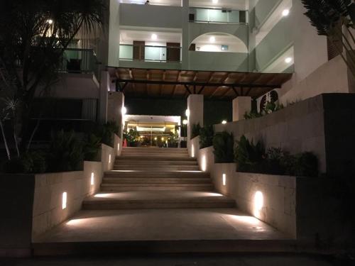 a stairway leading to a building at night at Cancun, Ocean Dream, Beautiful Aparment, Heart of the Hotel Zone in Cancún