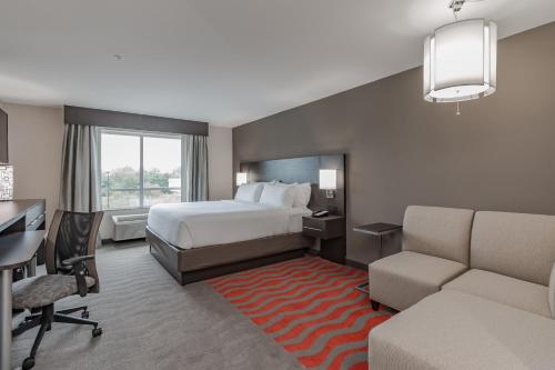 a hotel room with a bed and a desk at Holiday Inn Mishawaka by IHG in Mishawaka