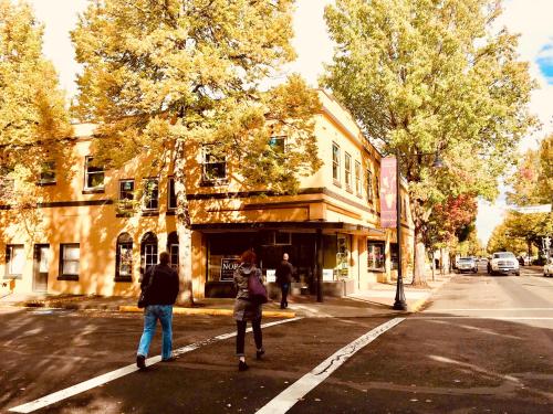 a group of people crossing a street in a crosswalk at Douglas On Third in McMinnville