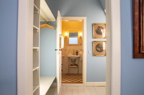 a hallway with a bathroom with a sink at Fuglsang Herregaard Hotel in Nykøbing Falster
