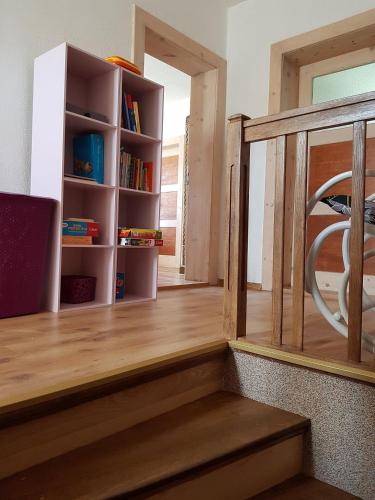 a stairway with a book shelf and a book case at Agroturystyka Nad Bobrem in Pilchowice