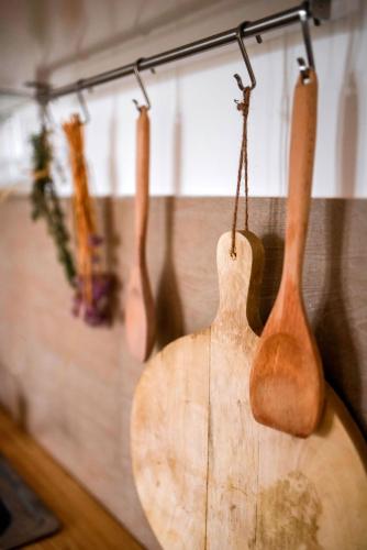a group of wooden guitars hanging on a wall at House of the Golden Horse in Hosszúréti Lovas Major in Törökbálint