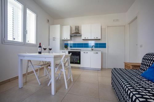 a kitchen and living room with a table and chairs at Terrazza Montalbano in Punta Secca