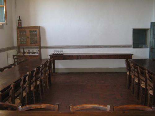 an empty room with chairs and a long table at Villa Morghen in Settignano