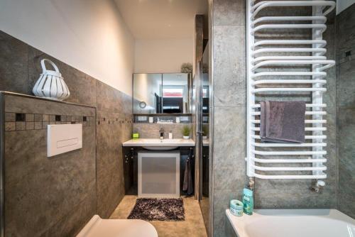a bathroom with a sink and a toilet at mountain-view-apartments de in Thale