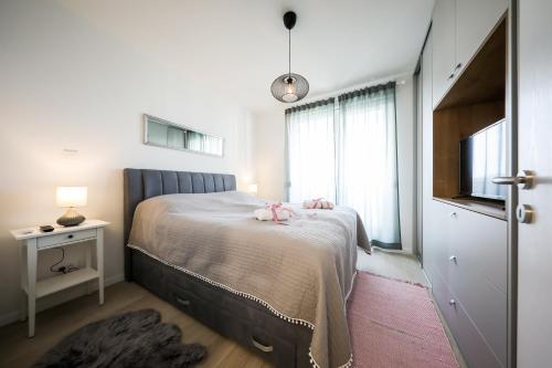 a bedroom with a bed and a television in it at Allegro Exclusive Suite 2 with parking in Zadar