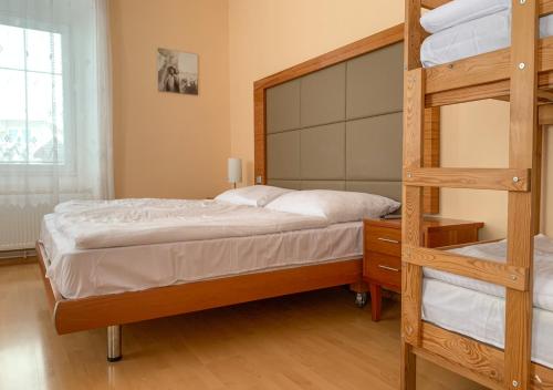 a bedroom with two bunk beds and a ladder at Penzion Mlýnický Dvůr in Červená Voda
