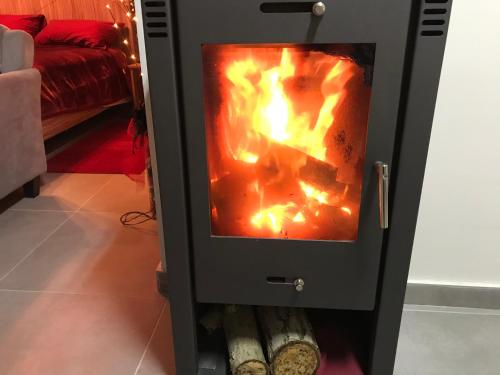 a stove with a fire inside of it at SOFROS VALLEY HILLS CHALET in Ayios Mamas