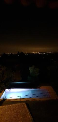 a night view of a building with blue lights at AltaVista in Vitorino dos Piães