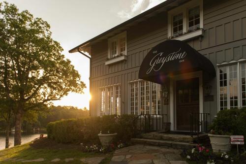 a restaurant with the sun setting behind a building at The Greystone Inn in Lake Toxaway