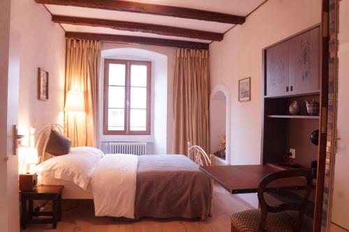 מיטה או מיטות בחדר ב-Maison Junod