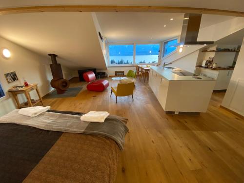 a large room with a kitchen and a living room at Otium-Oberhofen in Oberhofen am Thunersee