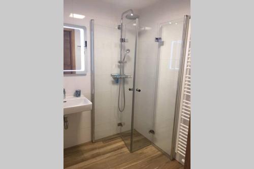 a bathroom with a shower and a sink at Sprungschanze Haus in Murau