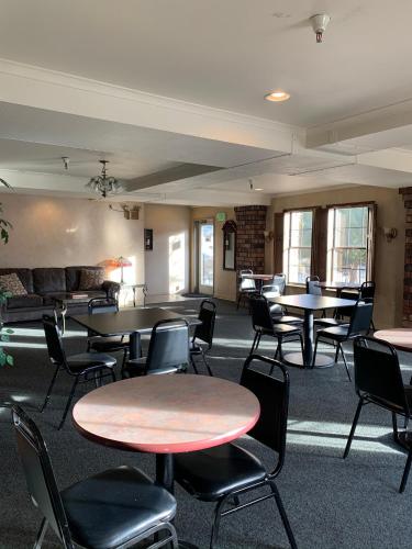 an empty room with tables and chairs and tablesktop at Hardman House in Carson City