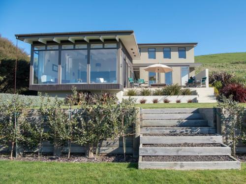 a house with a view of the ocean at Kotare Point Paradise - Akaroa Holiday Home in Akaroa