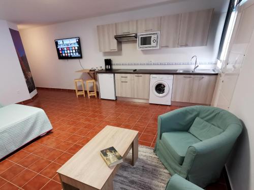 a living room with a couch and a chair and a table at Casa del Sur, en el Sur de Tenerife in Granadilla de Abona