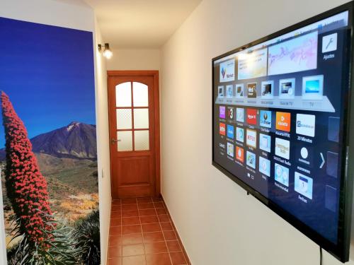 a flat screen tv hanging on a wall at Casa del Sur, en el Sur de Tenerife in Granadilla de Abona