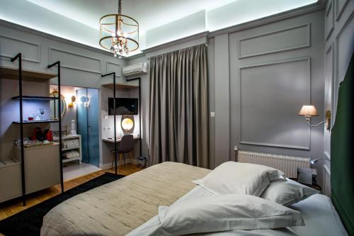a bedroom with a large bed and a desk at Esperia Boutique Hotel in Agrinion