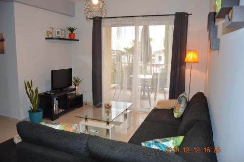 a living room with a couch and a glass table at Luxury Apartment in Paphos