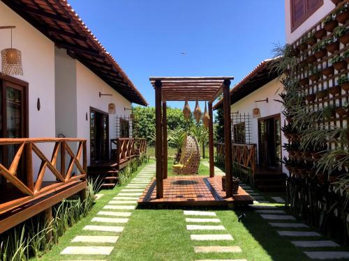 an entrance to a house with a wooden gate at Vila Lua de Taipu - Taipu de Fora in Barra Grande