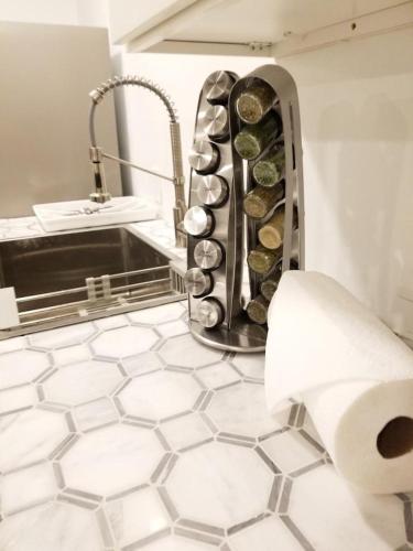 a bathroom with a sink and a roll of toilet paper at 7 BR- Sleeps 15! Famous Lakefront Amazing Property! in New Orleans