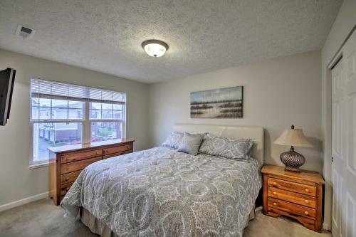 a bedroom with a bed with a dresser and a window at Arts and Design District Condo Steps to Monon Trail in Carmel