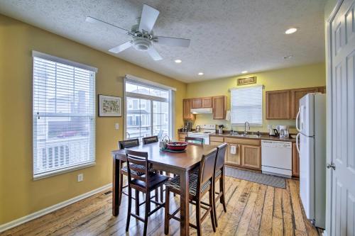 a kitchen with a table and chairs and a refrigerator at Arts and Design District Condo Steps to Monon Trail in Carmel