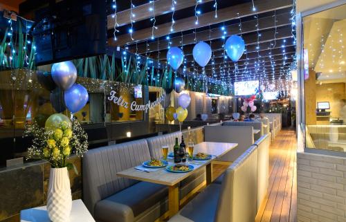 a restaurant with blue balloons and a table with food at Turrim Dei Hotel Boutique in Barbosa