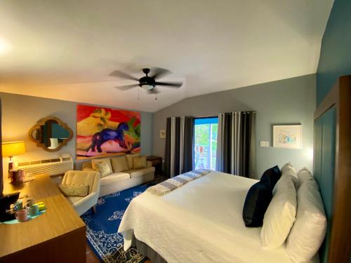 a bedroom with a bed and a living room at Blue Horizon Boutique Resort in Vieques