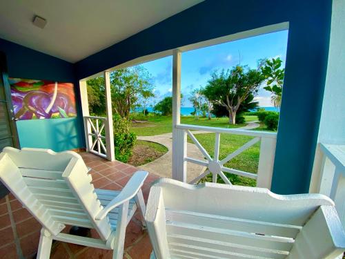 two chairs on a porch with a view of the ocean at Blue Horizon Boutique Resort in Vieques
