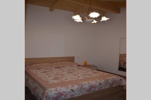 Schlafzimmer mit einem Bett und einem Kronleuchter in der Unterkunft La Casetta in Santa Margherita