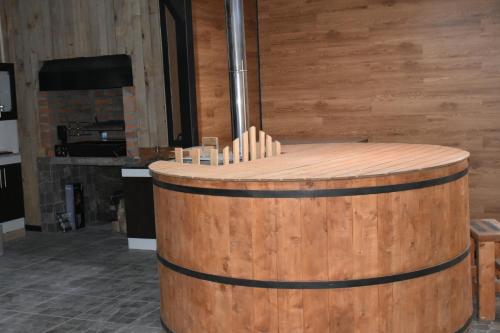 a wooden barrel in a room with a fireplace at El Granero de la Abuela in Futrono