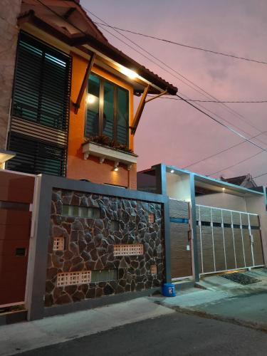 a house with a window and a stone wall at Jogja City Residence in Yogyakarta