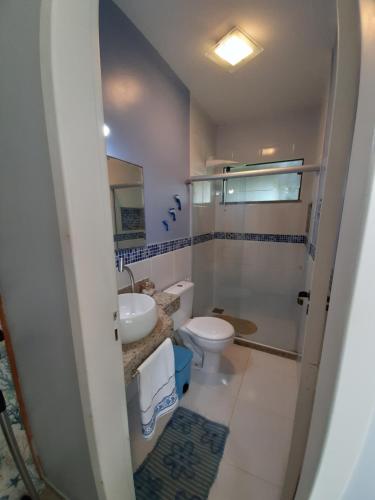 a bathroom with a toilet and a sink at Casa na Praia do Foguete in Cabo Frio