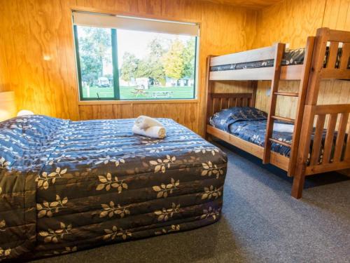 a bedroom with two bunk beds and a window at Motueka Apartment in Motueka