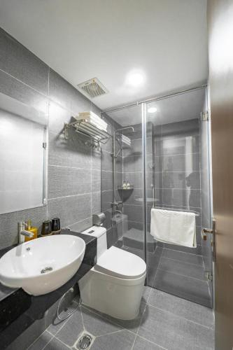 a bathroom with a sink and a toilet and a shower at Larosa Hotel Nha Trang in Nha Trang