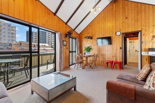 a living room with a couch and a table at Downtown Mountview - Mt Maunganui Holiday Home in Mount Maunganui