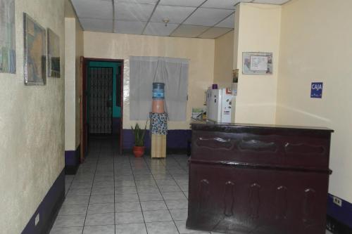 a hallway of a hospital with a room with a door at Hostal Nicaragua Guest House in Managua