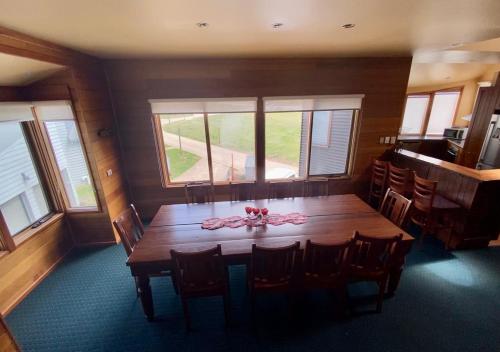 a dining room with a wooden table and chairs at Camelot in Dinner Plain