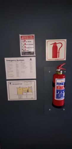 a refrigerator with a fire hydrant and signs on it at Villa Vue in Kleinbaai