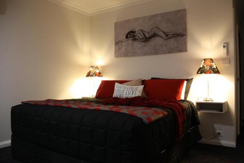 a bedroom with a bed with two lamps on it at Silverdown Luxury king rooms OR Apartment in Orange