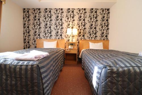 מיטה או מיטות בחדר ב-Hotel Premium Green Sovereign