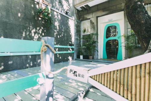 a house with a blue door and a bench at 阿信輕旅 in Tainan
