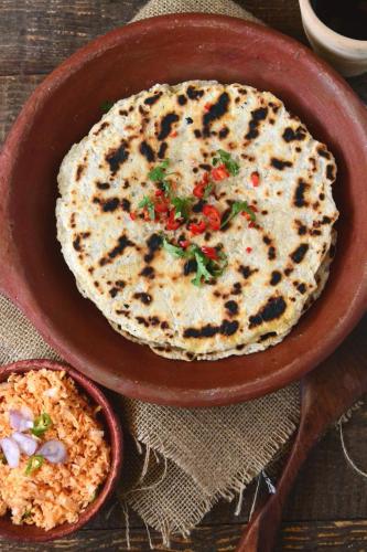 a plate of food with a tortilla and a bowl of rice at River Cottage in Wellawaya
