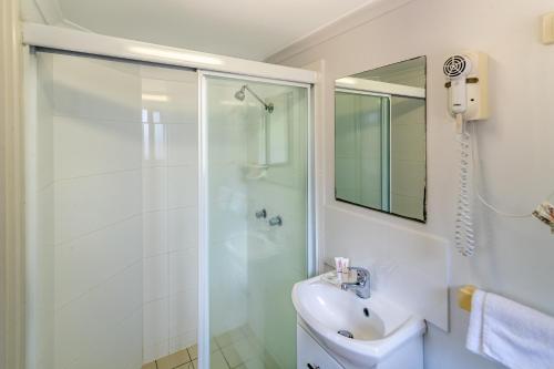 a bathroom with a shower and a sink at Ingenia Holidays Kingscliff in Chinderah