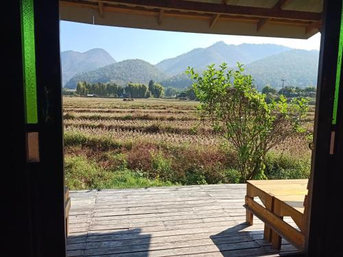 a view of a field from the porch of a house at Ing Doi Guest House in Pai